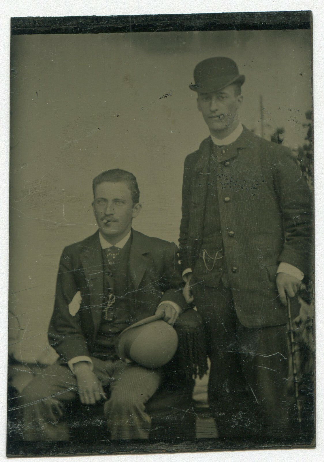 TWO MEN W/CIGARS, BOWLER HATS AND CANE. TINTYPE.