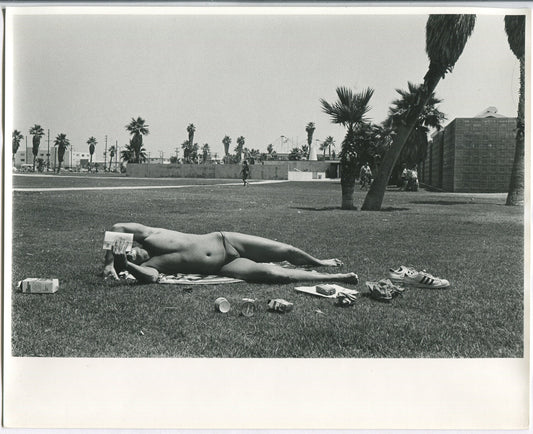 YOUNG MAN READING,SUNBATHING W/ ZINC OXIDE ON LIPS.B&W 8X10.1970s B&W 8x10