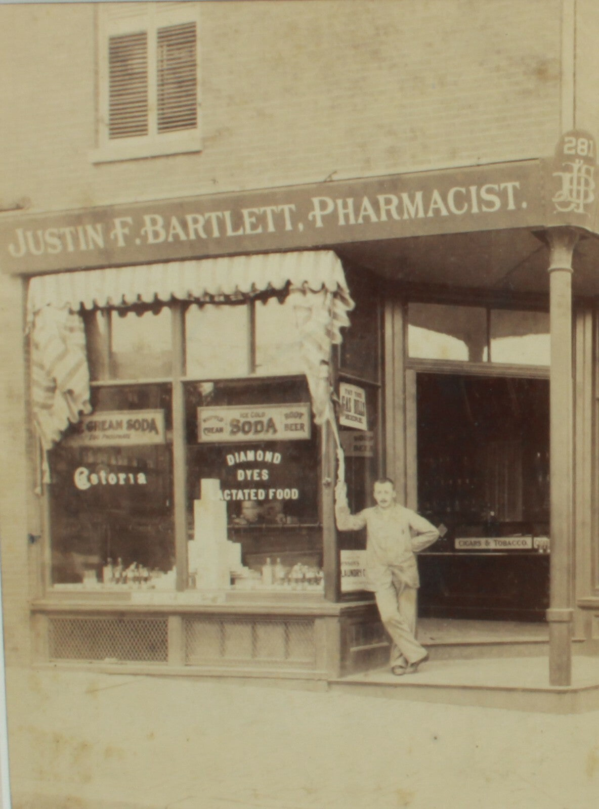 JUSTIN F. BARTLETT  PHARMACIST STORE CAB CARD IN 8X10 FRAME.