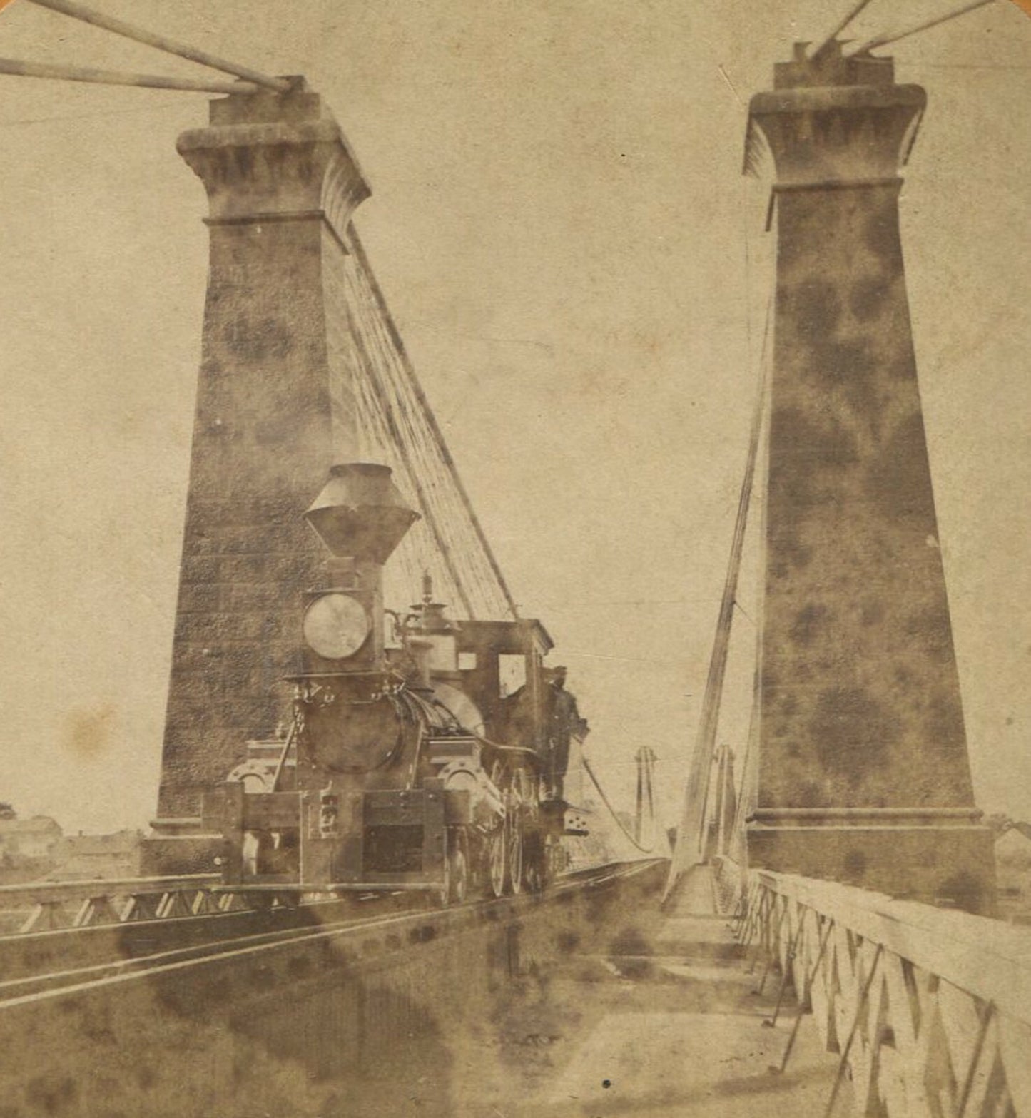 TRAIN, STEAM ENGINE CROSSING SUSPENSION BRIDGE, NIAGARA. STEREOVIEW.