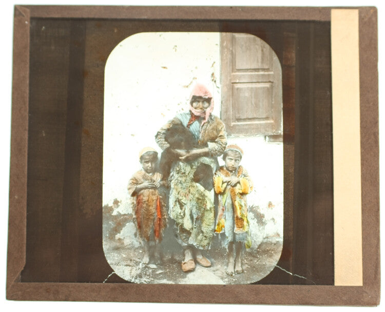COLOR PHOTO ON GLASS OF INDIGENOUS MOTHER & CHILDREN IN BRIGHT CLOTHING
