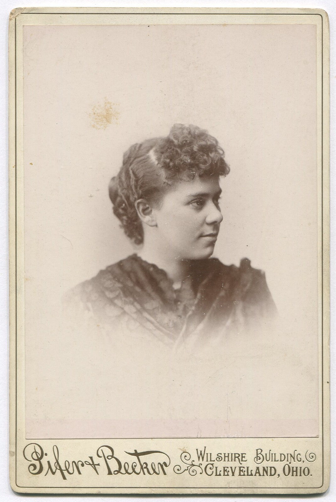 WOMAN, CURLY HAIR, PROFILE POSE. CABINET CARD. CLEVELAND, OHIO.