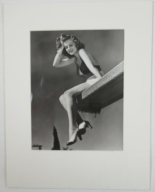 ACTRESS CONSTANCE MOORE SITTING ON DIVING BOARD. 8X10 B&W IN 11X14 ARCHIVAL MAT.