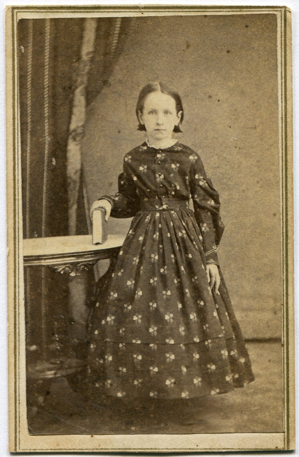YOUNG GIRL, STANDING POSE W/BOOK, BUSY PATTERNED DRESS. CDV. SELINSGROVE, PA.