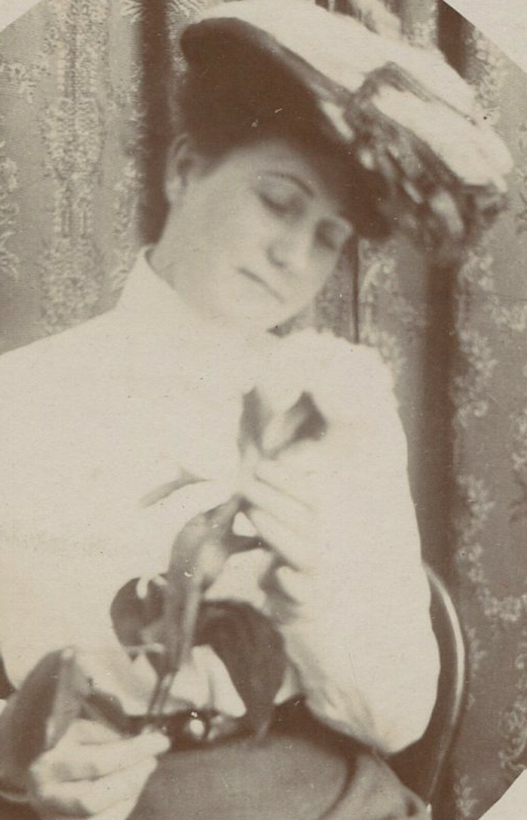 WOMAN IN HAT ADMIRING TULIP. 1890-1900. 6X5 IN.