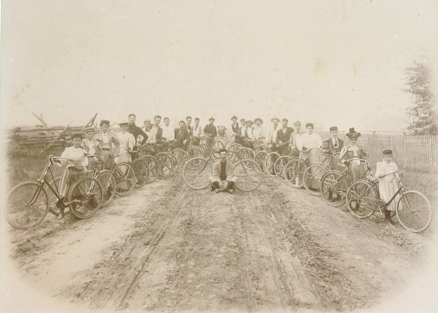 BICYCLISTS POSE ALONG DIRT ROAD. 7.5X10 INCH TONED SILVER PRINT IN 11X14 MAT.