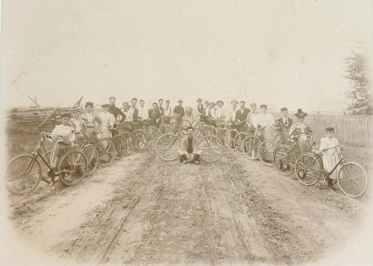 BICYCLISTS POSE ALONG DIRT ROAD. 7.5X10 INCH TONED SILVER PRINT IN 11X14 MAT.