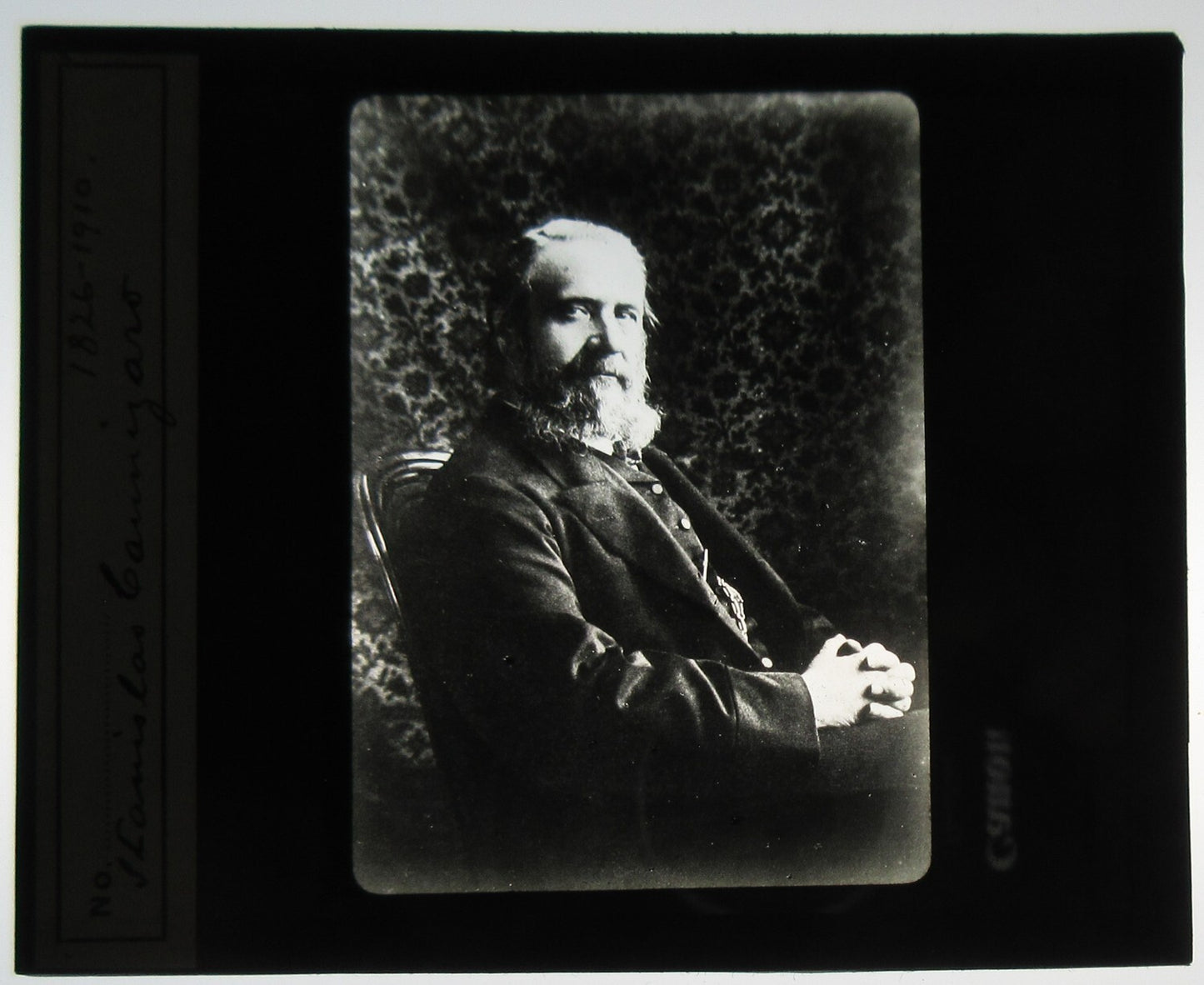 BEARDED MAN, RELAXED SEATED POSE. PORTRAIT. PHOTO ON GLASS.