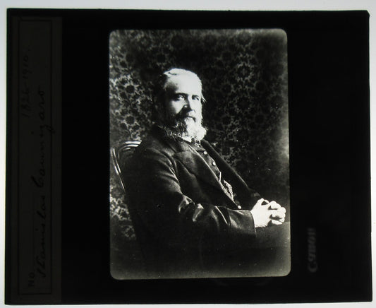 BEARDED MAN, RELAXED SEATED POSE. PORTRAIT. PHOTO ON GLASS.