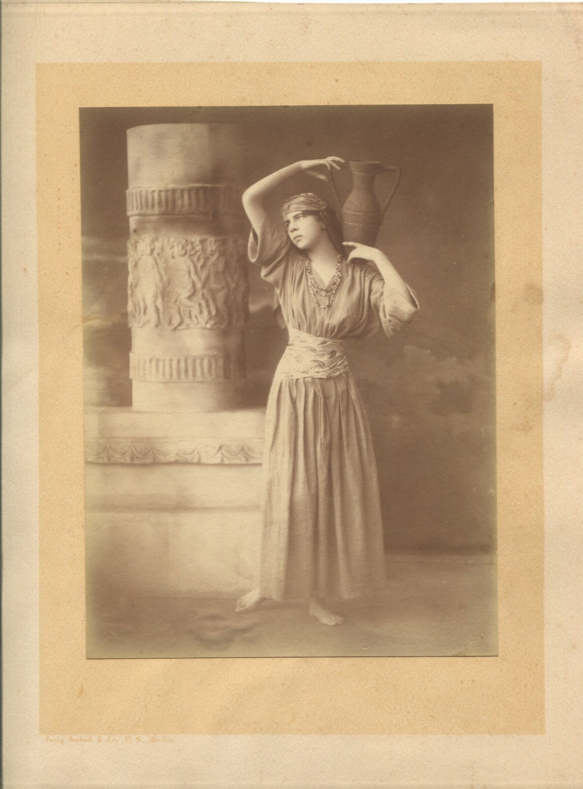 WOMAN W/VASE. TONED SILVER PRINT 8X6 ON 11X9 CARD. 1910-30.