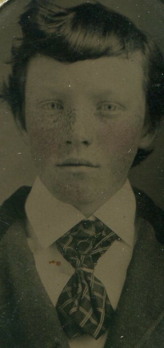 BOY W/WIDE TIE. TINTED TINTYPE, PERIOD PAPER MAT.