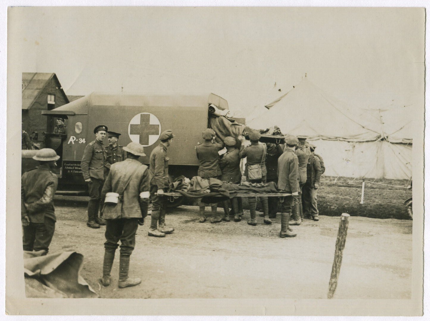 BRITISH TROOPS REMOVING GERMAN WOUNDED. WWI.  (8X10 REPRINT)