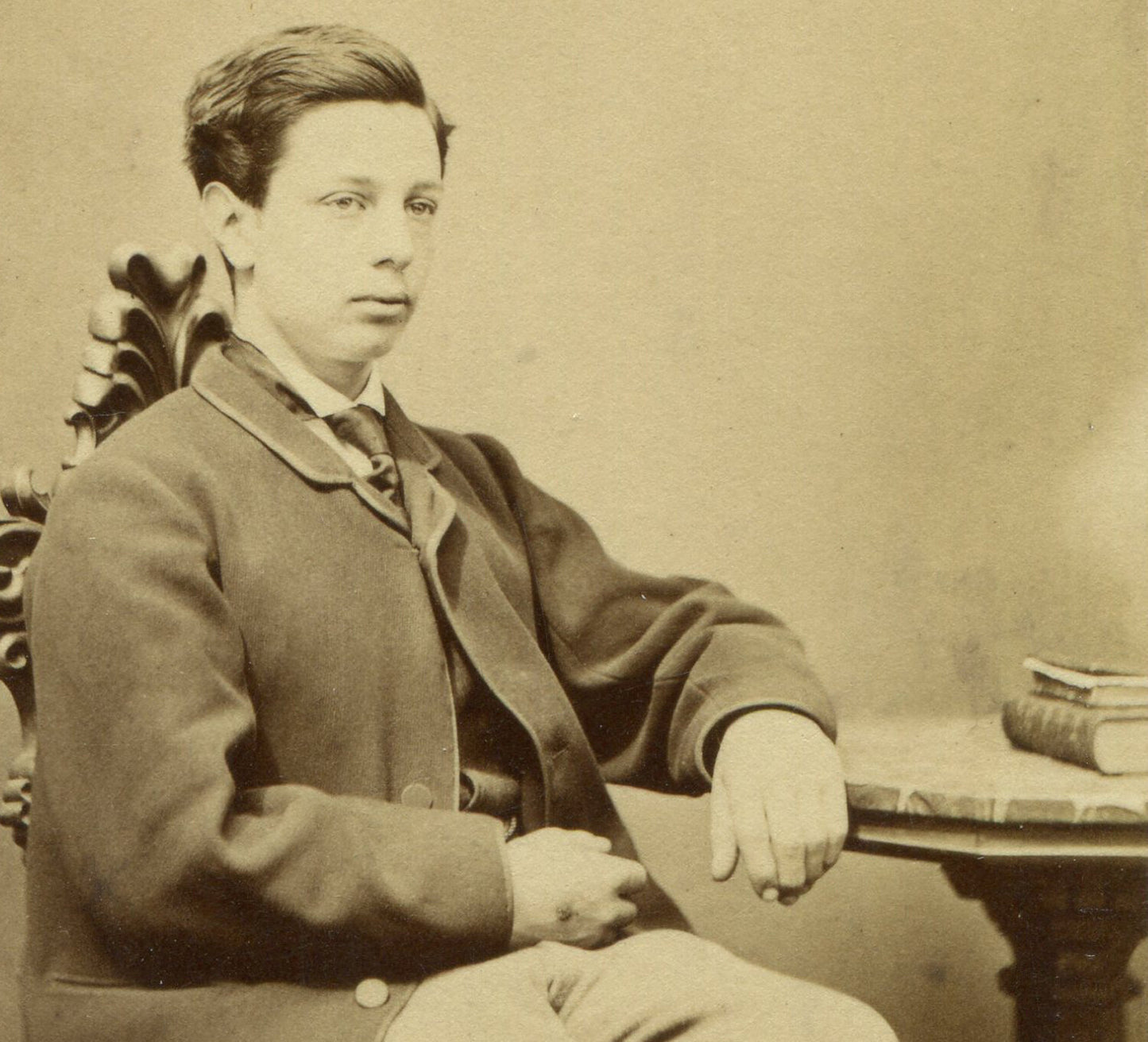 VERY YOUNG MAN SEATED AT TABLE W/BOOKS. CDV. WINCHESTER, ENGLAND.
