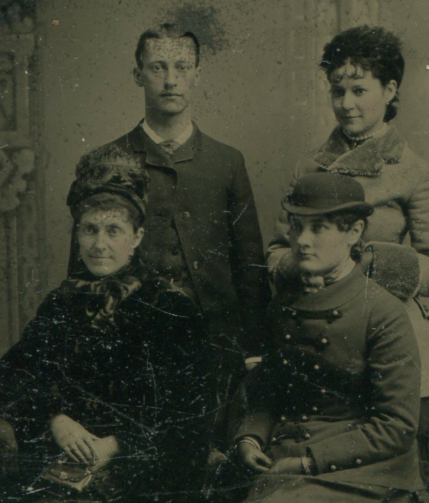 ADULT CHILDREN W/MOTHER. PAINTED BACKGROUND TINTYPE.