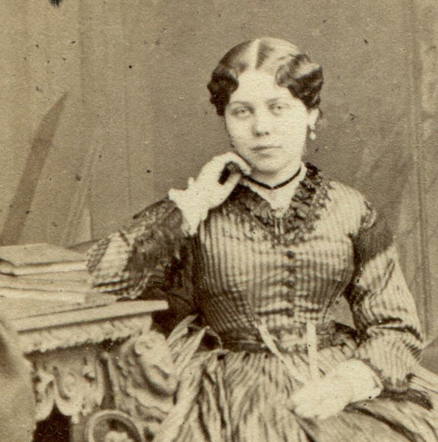 WOMAN, RELAXED SEATED POSE, HAND AT CHEEK. BOOKS ON TABLE. CDV. LONDON.