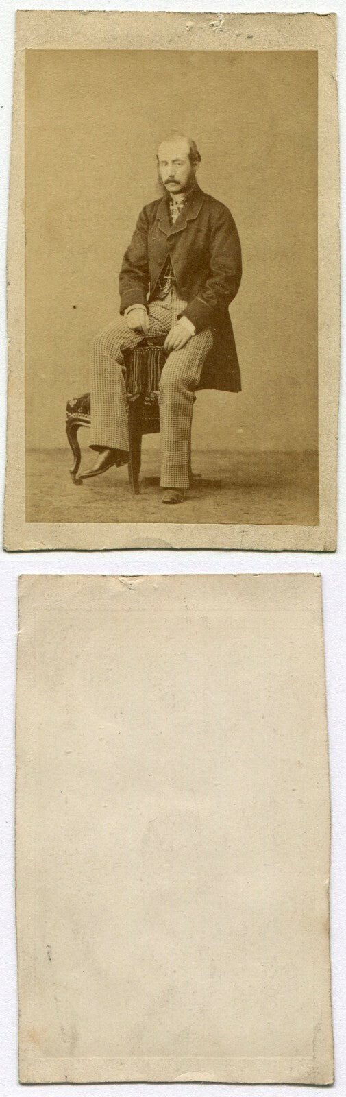 MAN UNCOMFORTABLY POSED ON CHAIR ARM. OUCH. CDV.