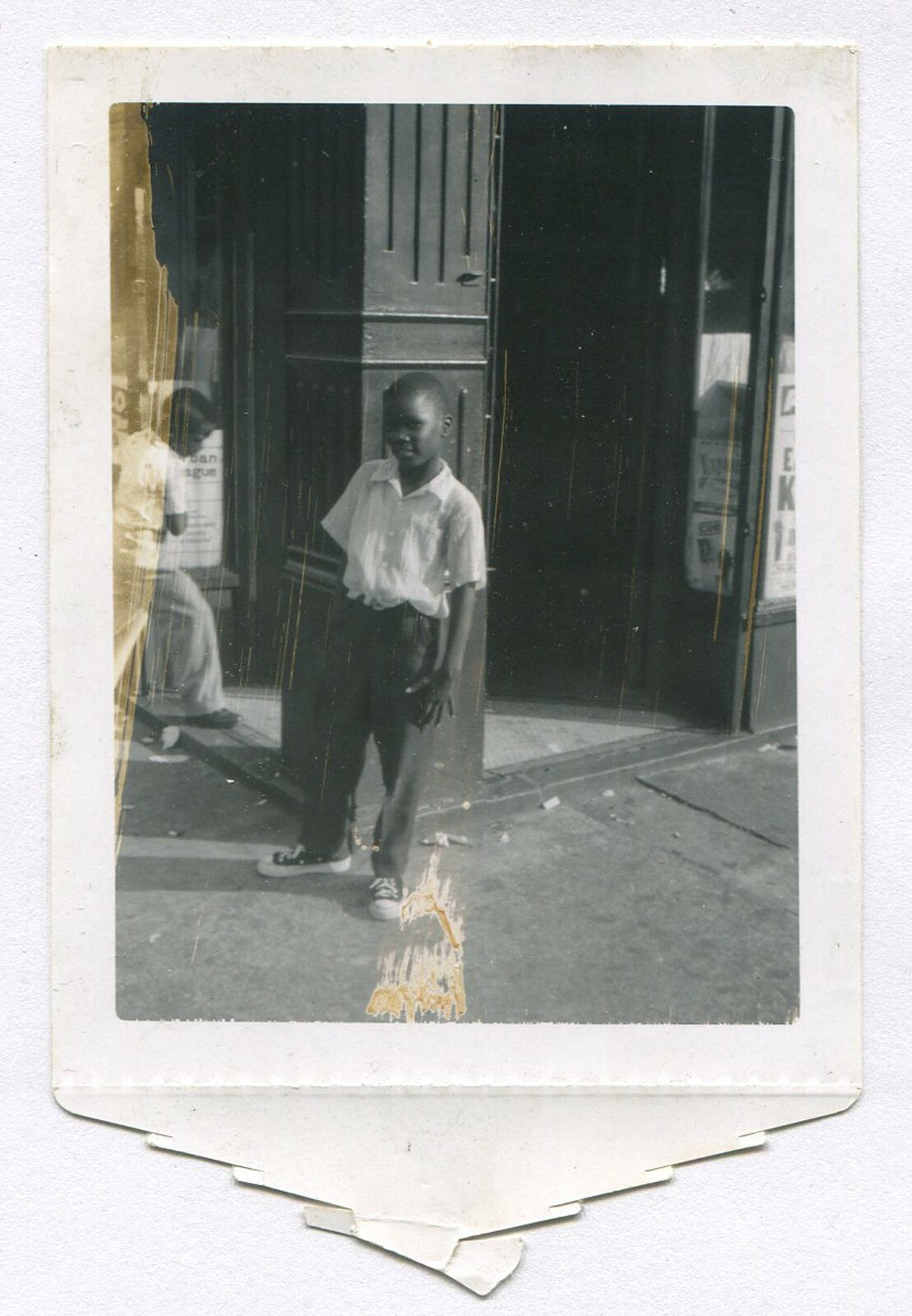 YOUNG AFRICAN AMERICAN BOY, RELAXED POSE. POLAROID PHOTO, 1950s