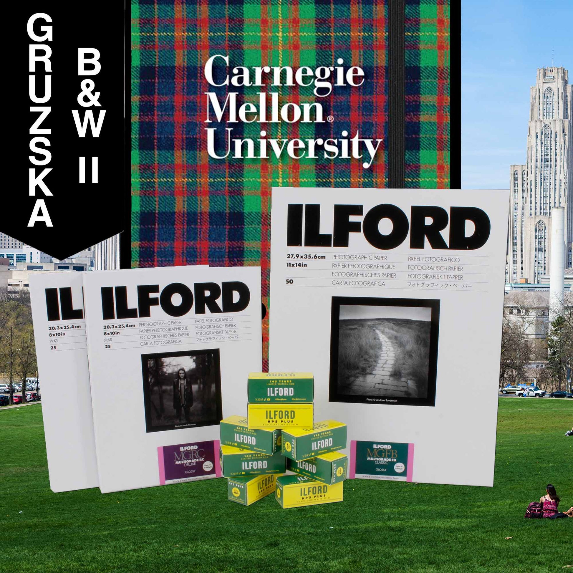 Ilford photographic paper and film boxes with Carnegie Mellon University and Gruzska branding on a grassy field.