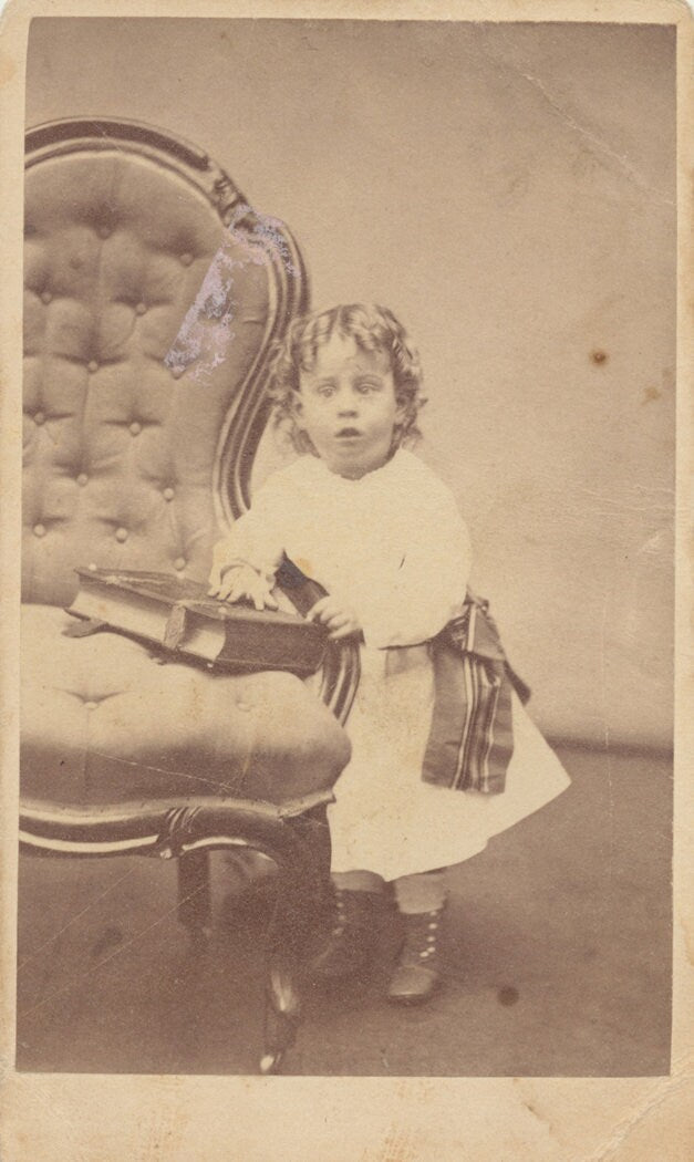 Young Child Perplexed by Large Book. CDV. Milford, Massachusetts, USA.