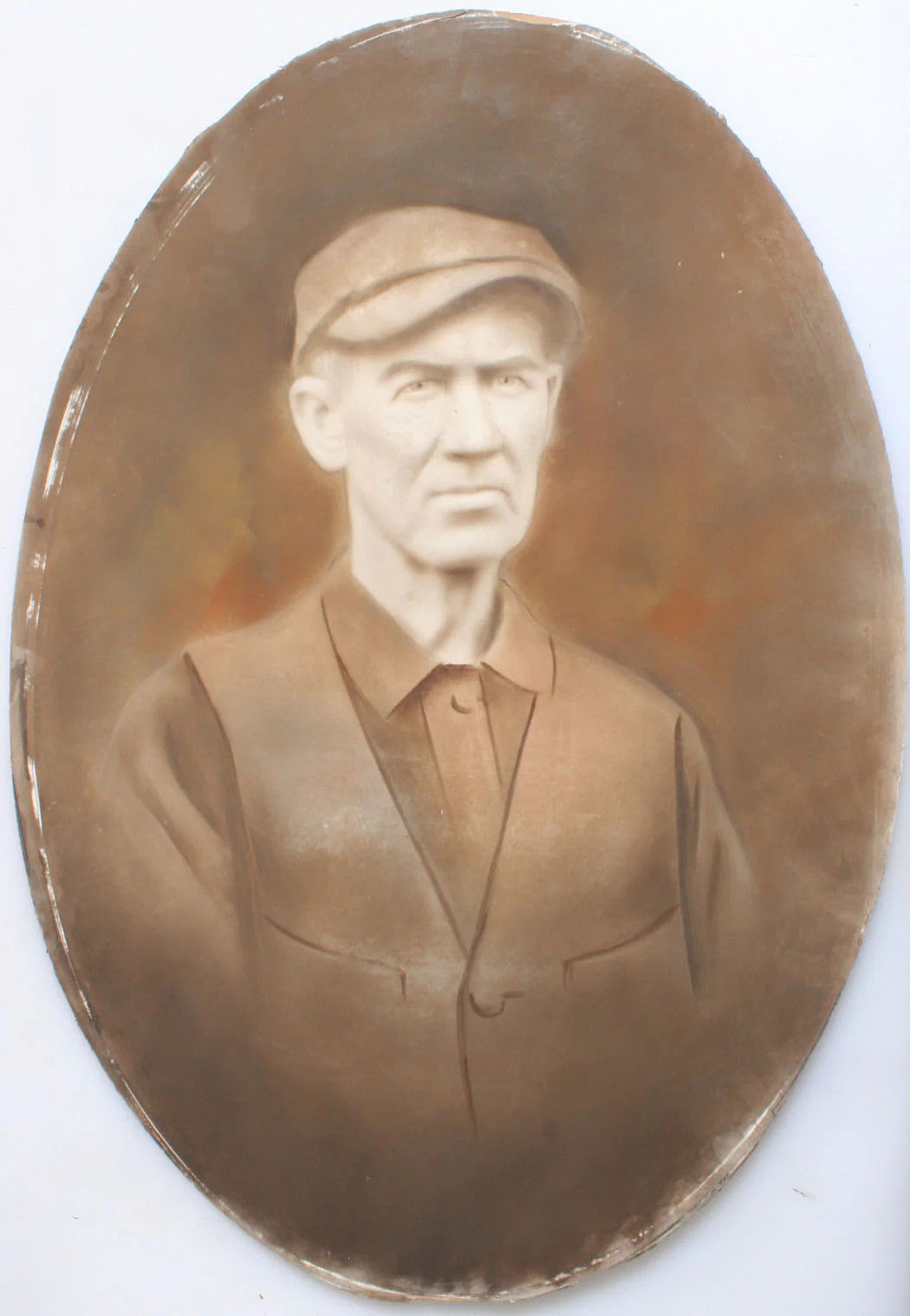 MAN IN NEWSBOY HAT, SEPIA  HAND TINTED PHOTO. OVAL, 19.5 X 13.75 INCHES.