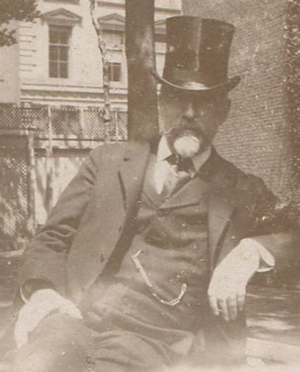 MAN IN TOP HAT SEATED ON PARK BENCH. CIRCA 1890.
