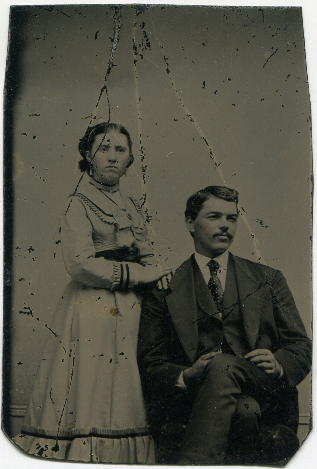 HANDSOME COUPLE, AFFECTIONATE POSE, NICE OUTFITS. TINTED TINTYPE.