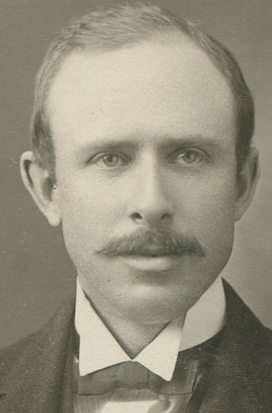 Vintage silver print portrait of mustached man with receding hairline, circa