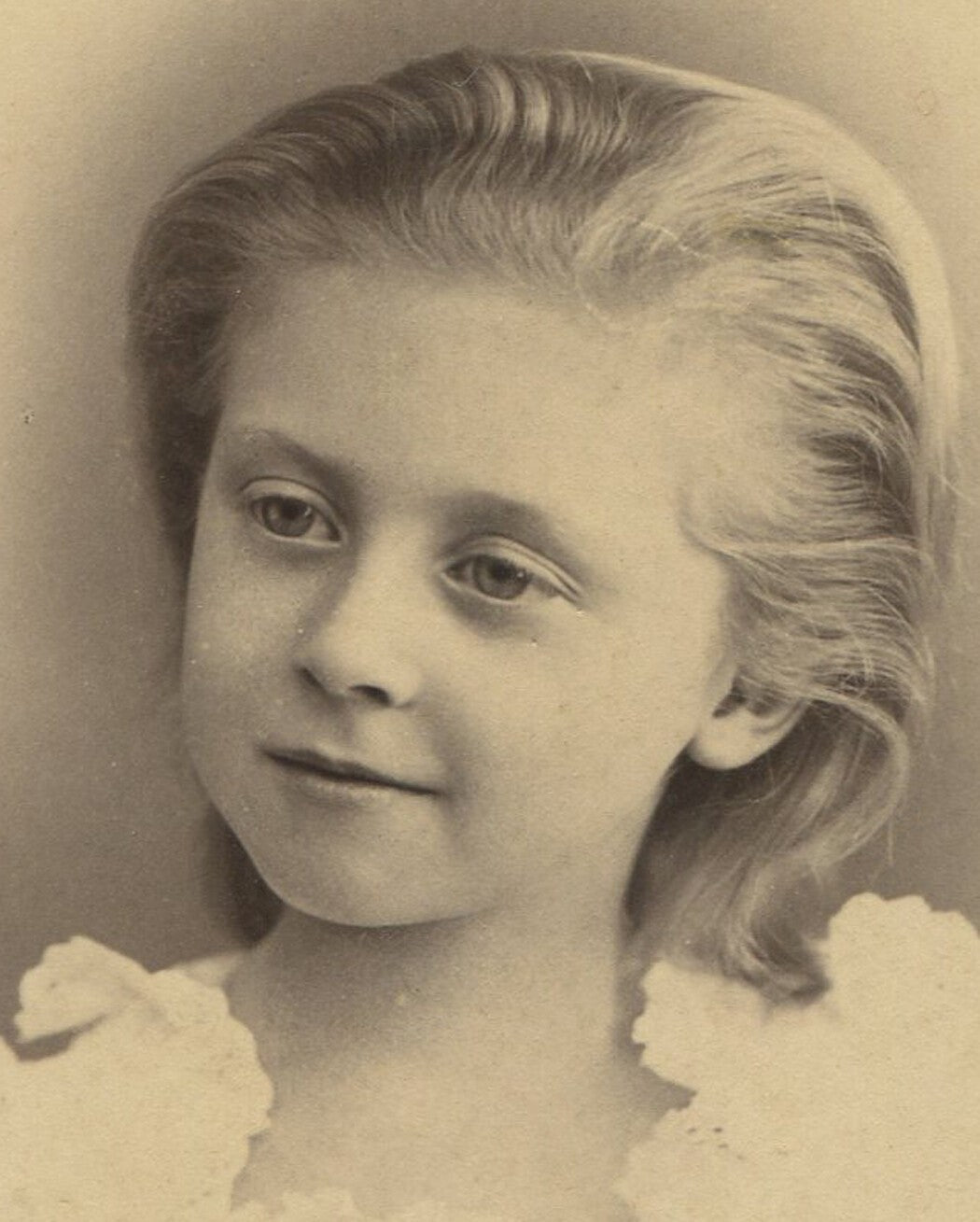 Vintage cabinet card portrait: young girl with thick blond hair slicked back,