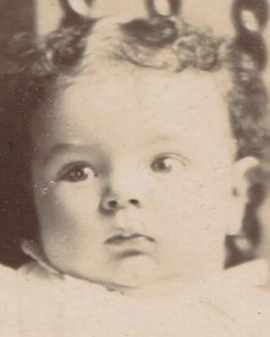 Vintage cabinet card: wide-eyed baby in odd chair, two-view portrait, historic