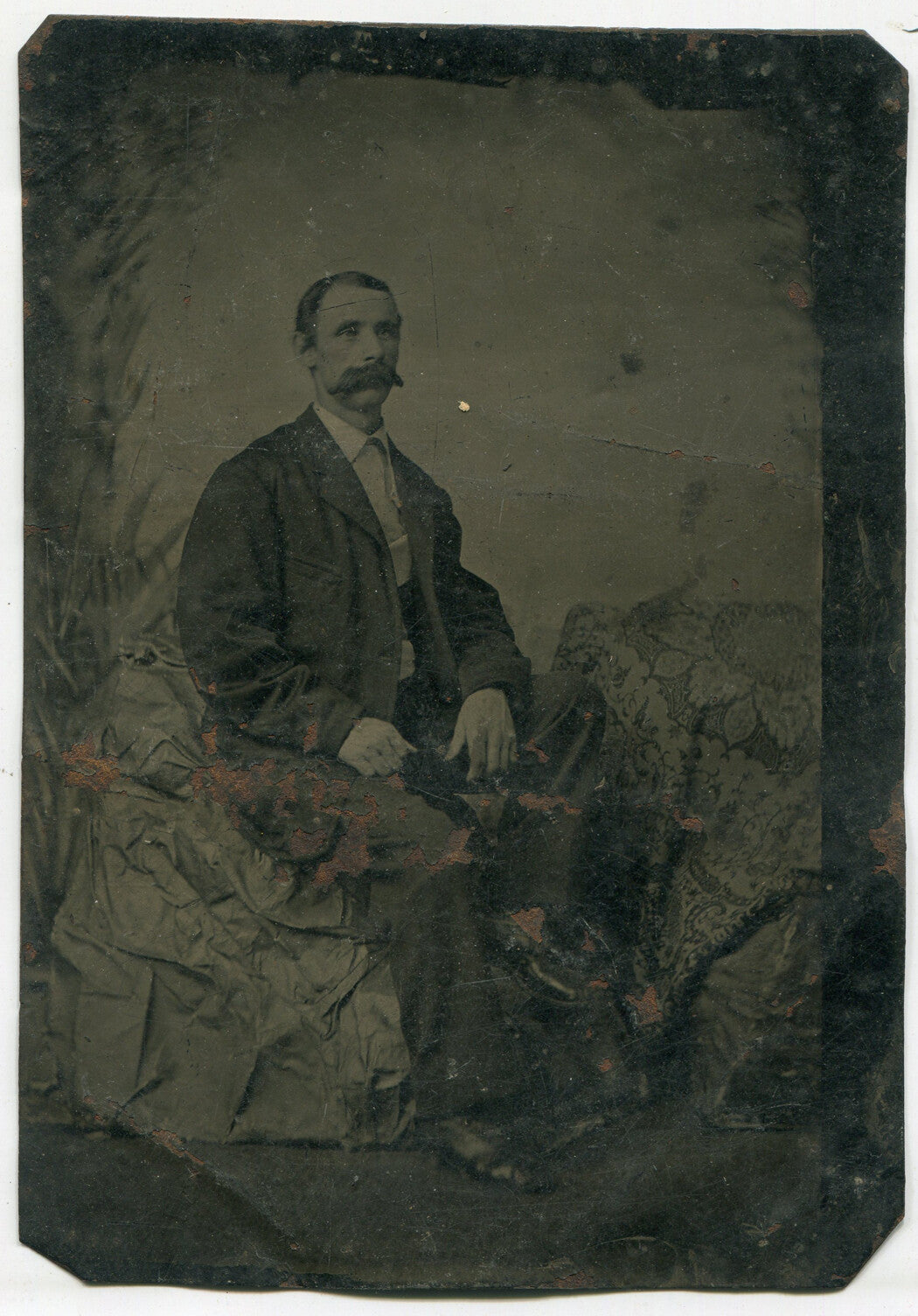 MAN W/BROOM MUSTACHE. TINTYPE, PAINTED BACKGROUND.