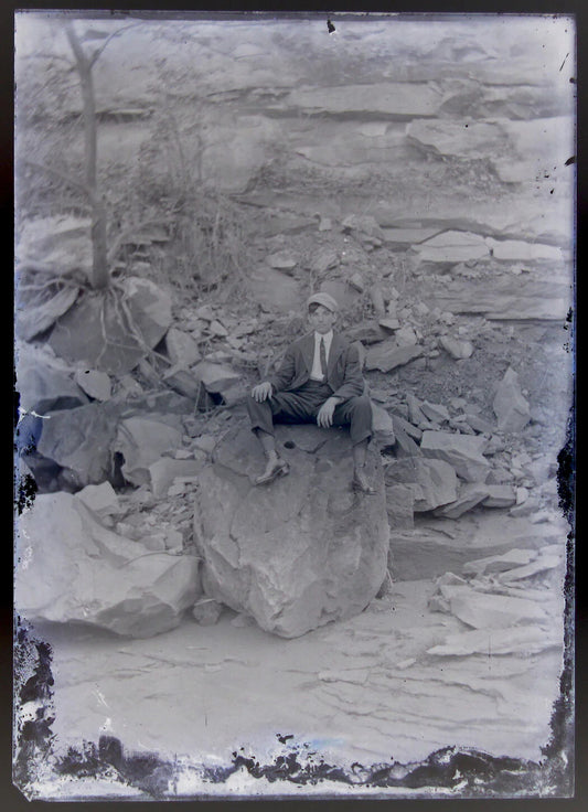 LONELY YOUNG MAN SITTING ON HUGE ROCKS. 5X7 GLASS PLATE NEGATIVE.