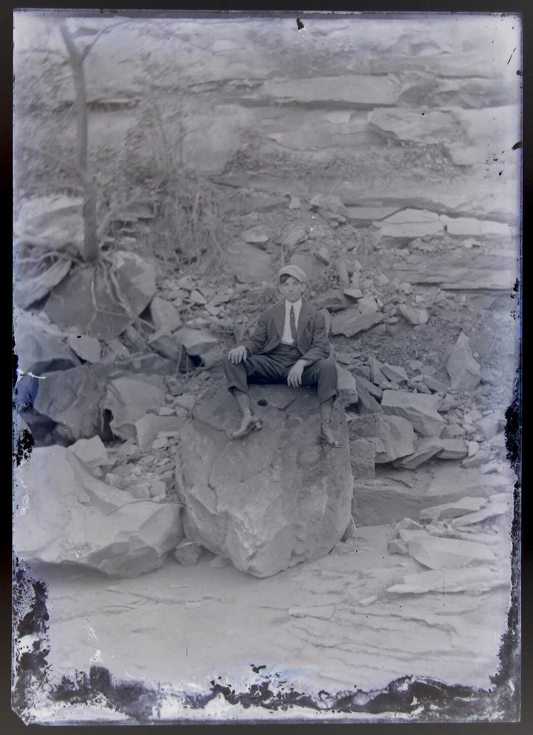 LONELY YOUNG MAN SITTING ON HUGE ROCKS. 5X7 GLASS PLATE NEGATIVE.