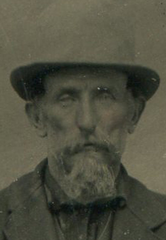 Vintage tintype portrait: Gruff man in hat with painted backdrop, authentic