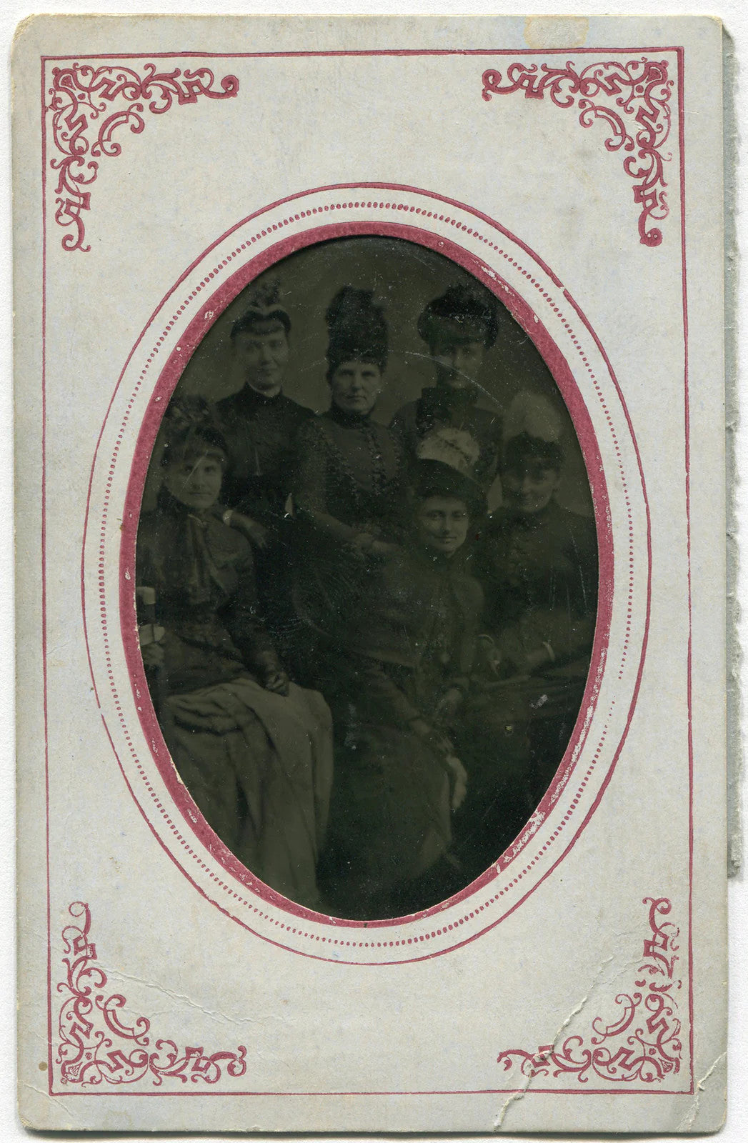 HALF DOZEN WOMEN, HALF DOZEN HATS. TINTYPE IN PERIOD PAPER MAT.