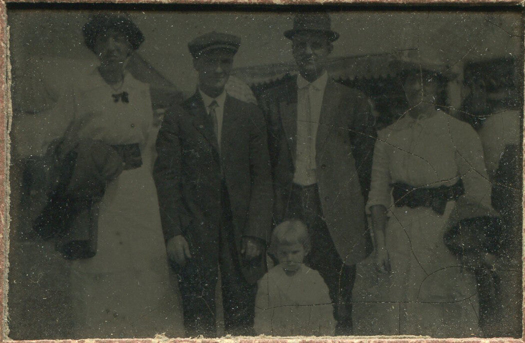 COUPLES IN HATS, ANGRY HATLESS CHILD. TINTYPE IN PERIOD PAPER MAT.