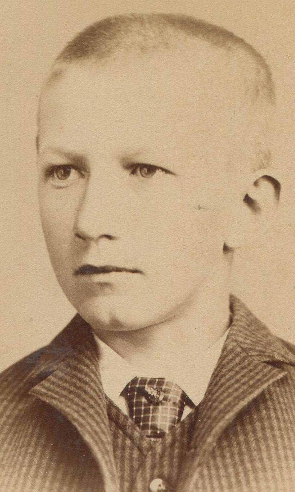 SAD BOY IN CHECKED SUIT WONDERING ABOUT HIS HAIR. CABINET CARD.