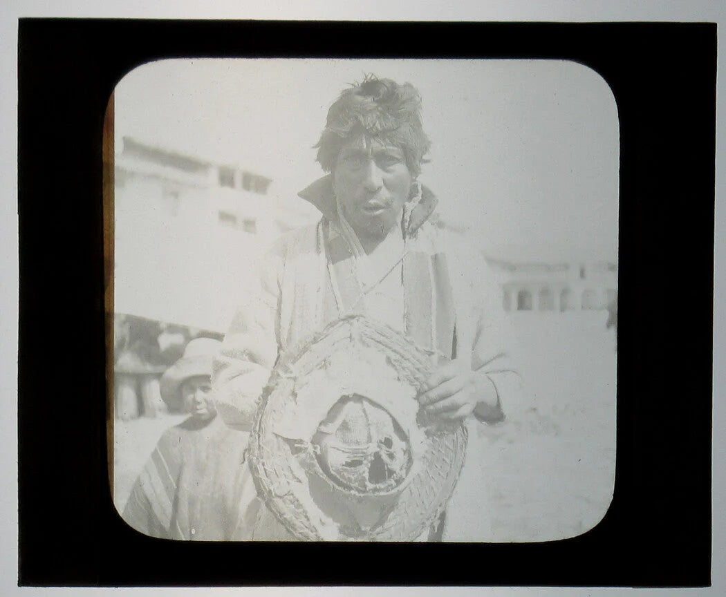 INDIGENOUS MAN HOLDING HAT. PERU. PHOTO ON GLASS.