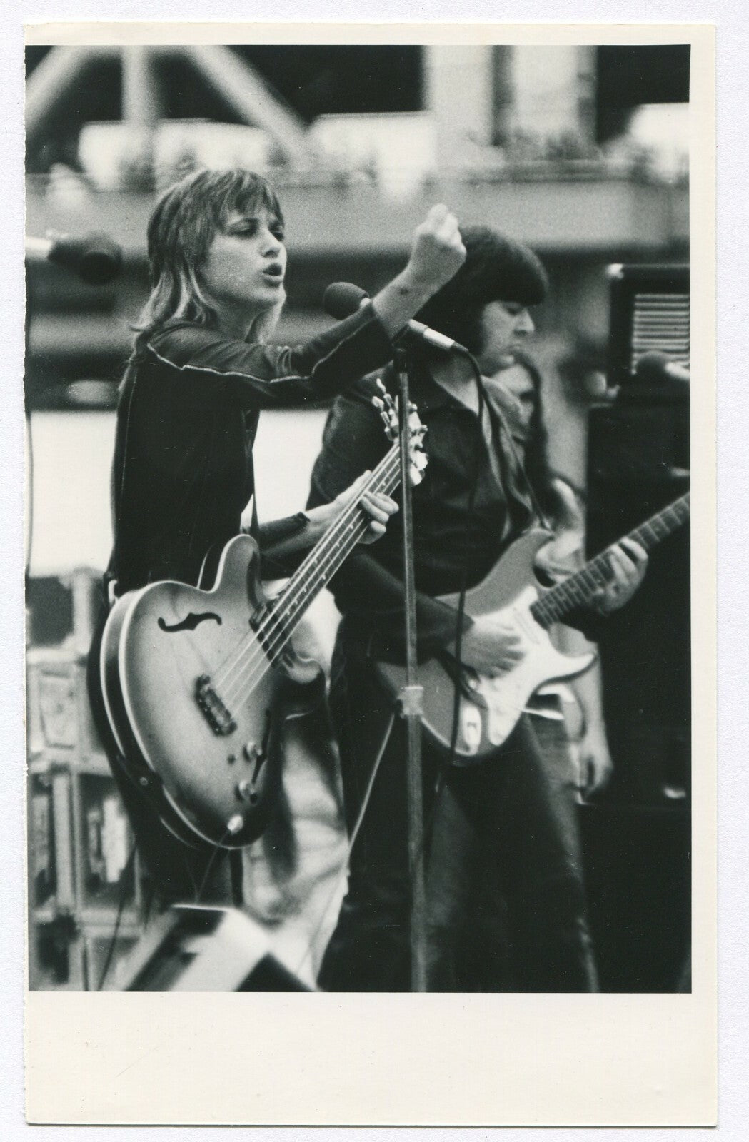 MUSICIAN, WOMAN PLAYING BASS GUITAR. 1970s.  B&W, 8 X 5 INCH PRINT.