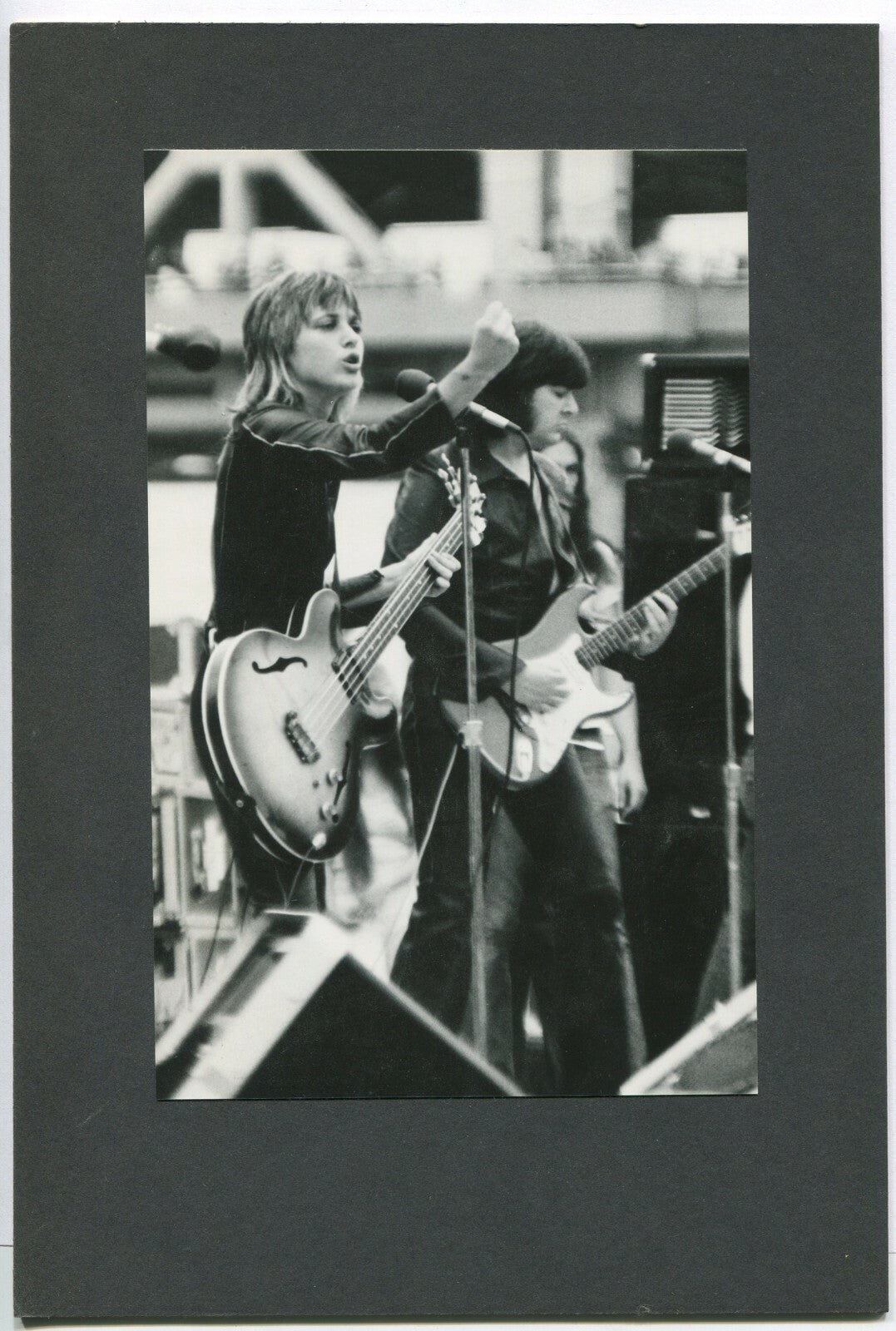 MUSICIAN, WOMAN PLAYING BASS GUITAR. B&W, 1970. 8X5 PHOTO ON 11X7.5 BOARD.