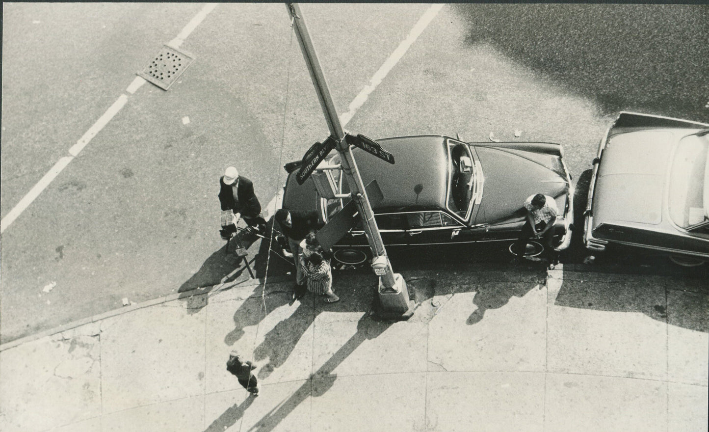 LOOKING DOWN ON PHOTOGRAPHER TAKING PHOTO AT SOUTHERN BLVD AT 163 ST,BRONX, N.Y.