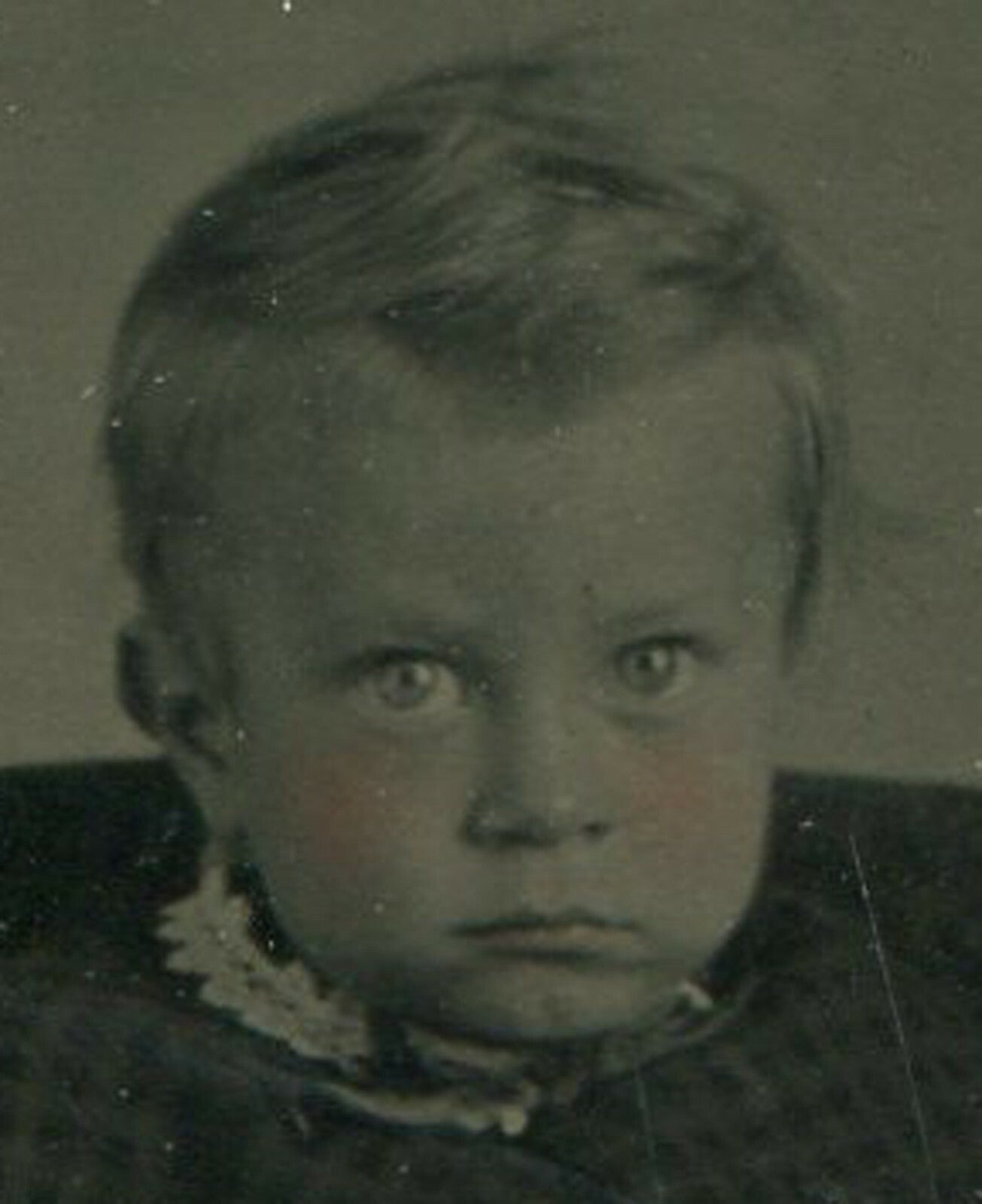 TODDLER LOOKING LIKE AN OPPRESSOR. TINTED TINTYPE IN PAPER MAT.