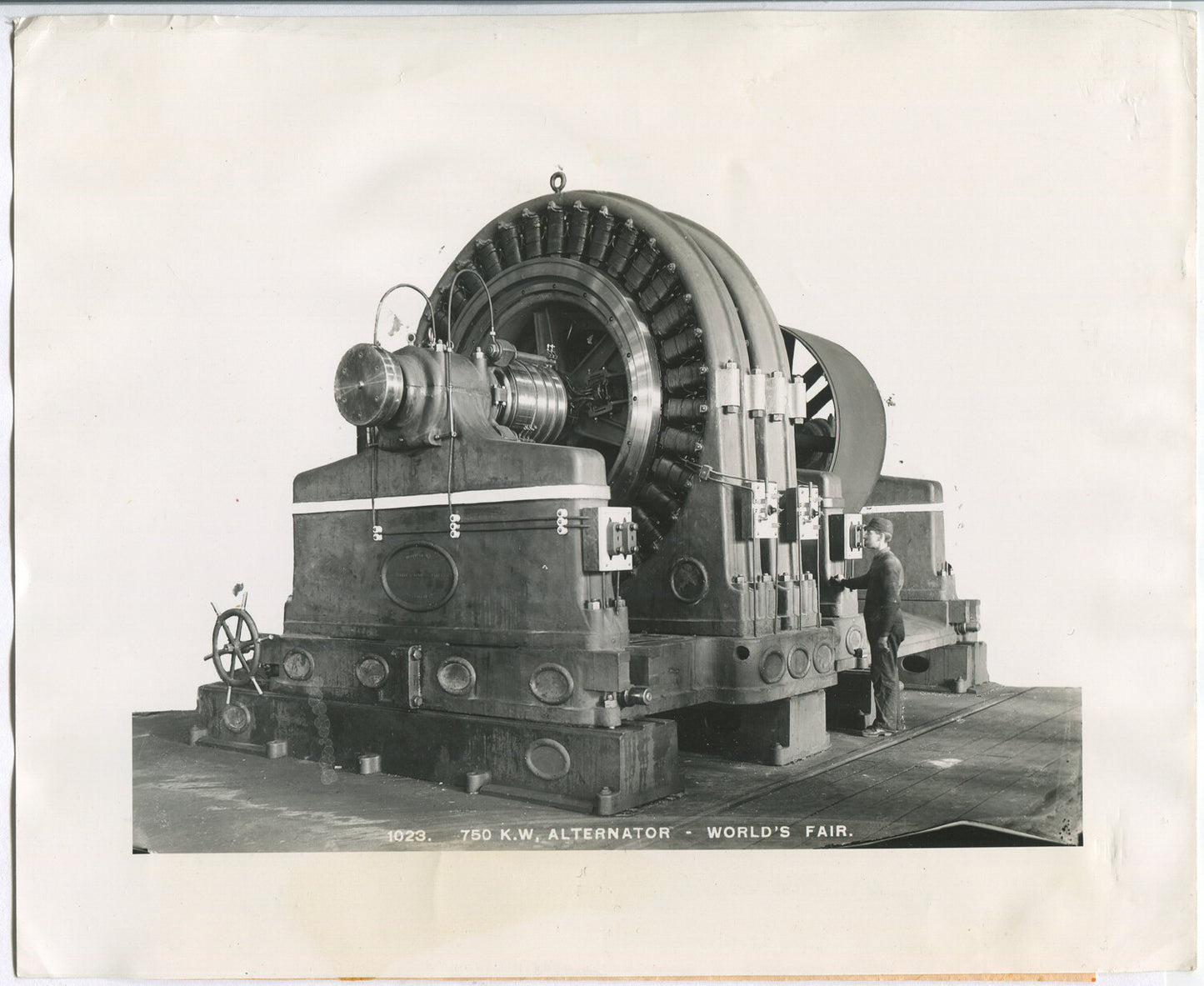 MAN GIVING SCALE TO HUGE WESTINGHOUSE ALTERNATOR. B & W 8X10 SILVER PRINT.