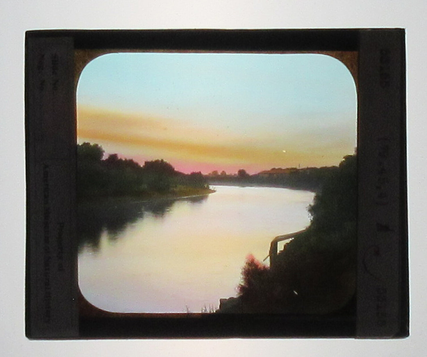 SACRAMENTO RIVER SUNSET. HAND COLORED PHOTO ON GLASS. TINTED LANTERN SLIDE.