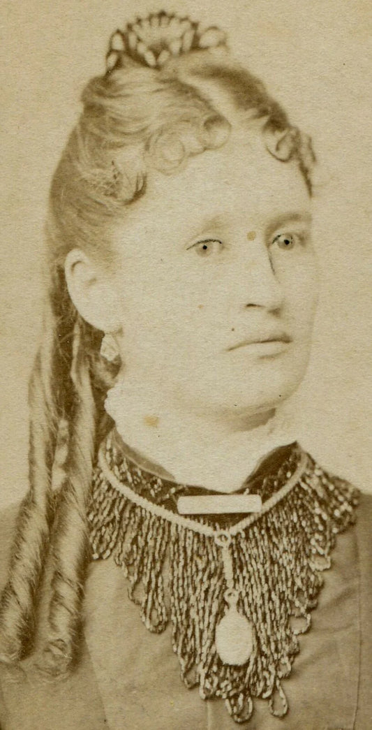 WOMAN W/FRINGE COLLAR, JEWELRY, EXTRA LONG RINGLET CURL. LANCASTER, WISCONSIN.