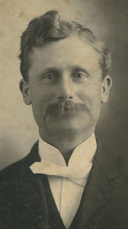 Vintage photo 5x3.5in oval silver print on 7.75x6in card, man with mischievous