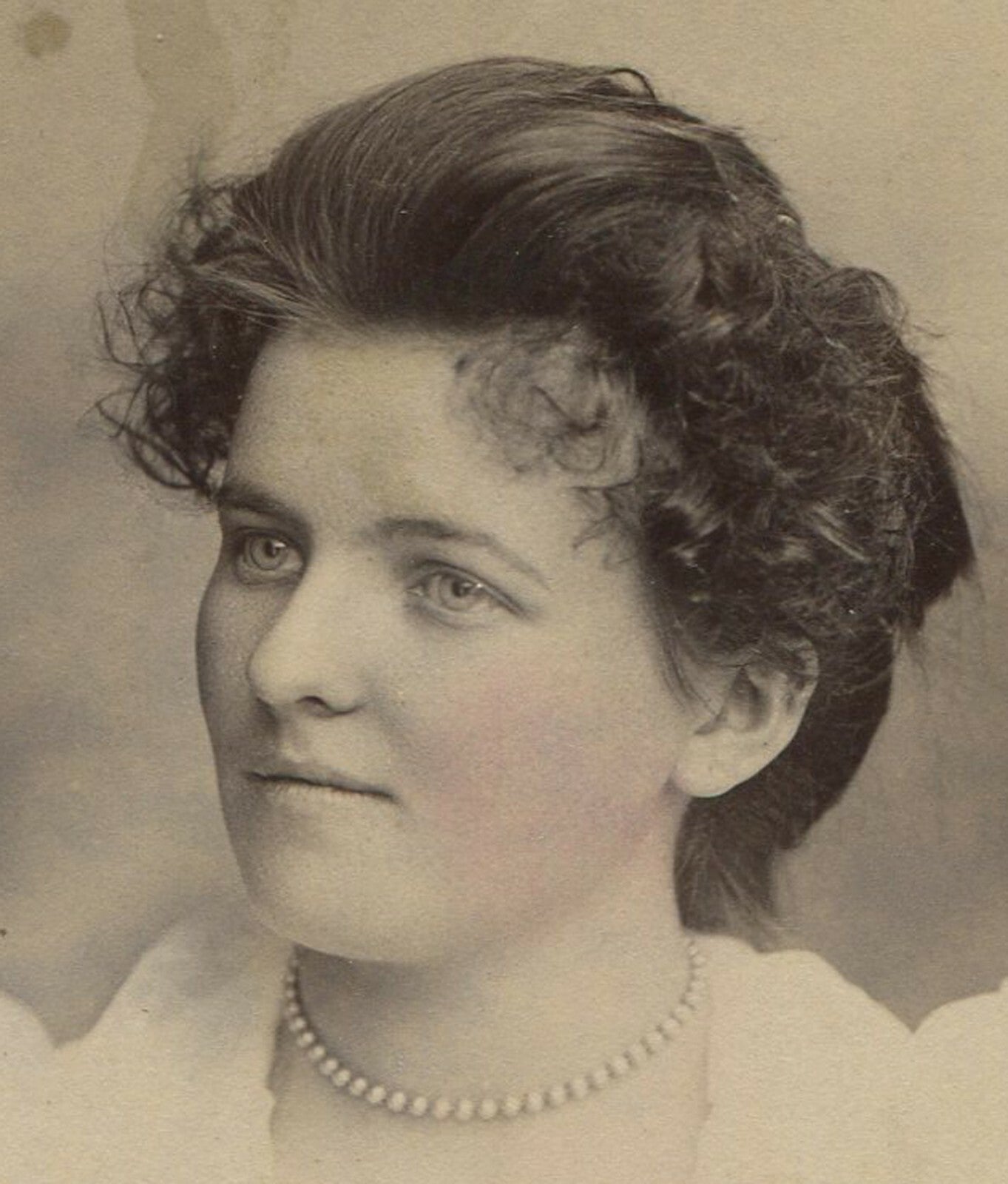 Vintage cabinet card portrait of a woman with pearl necklace, tinted New York
