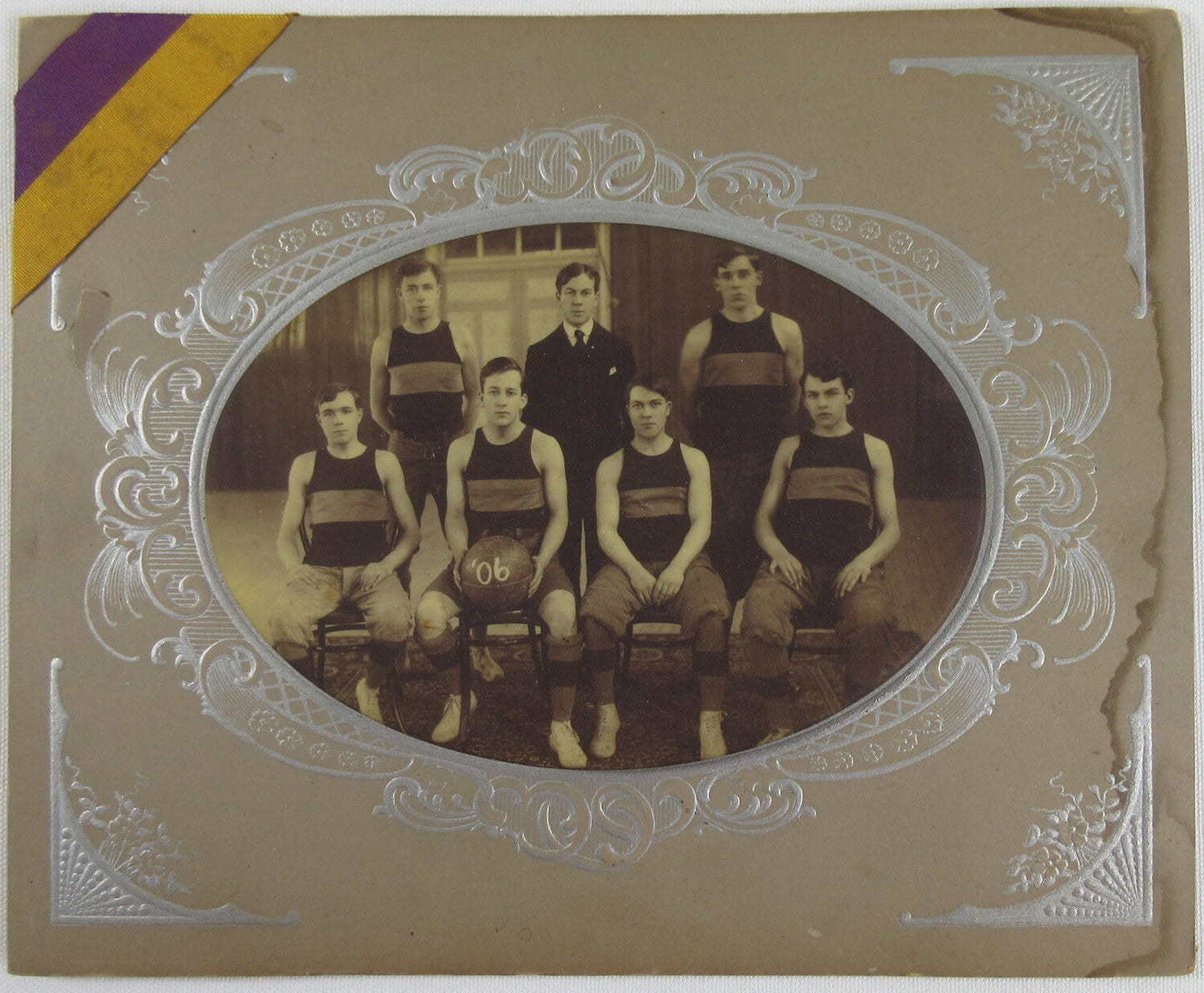 EARLY BASKETBALL TEAM, 1906. PHOTO ON 4.5X6.5 FABRIC BUTTON ON 8X10 CARD.