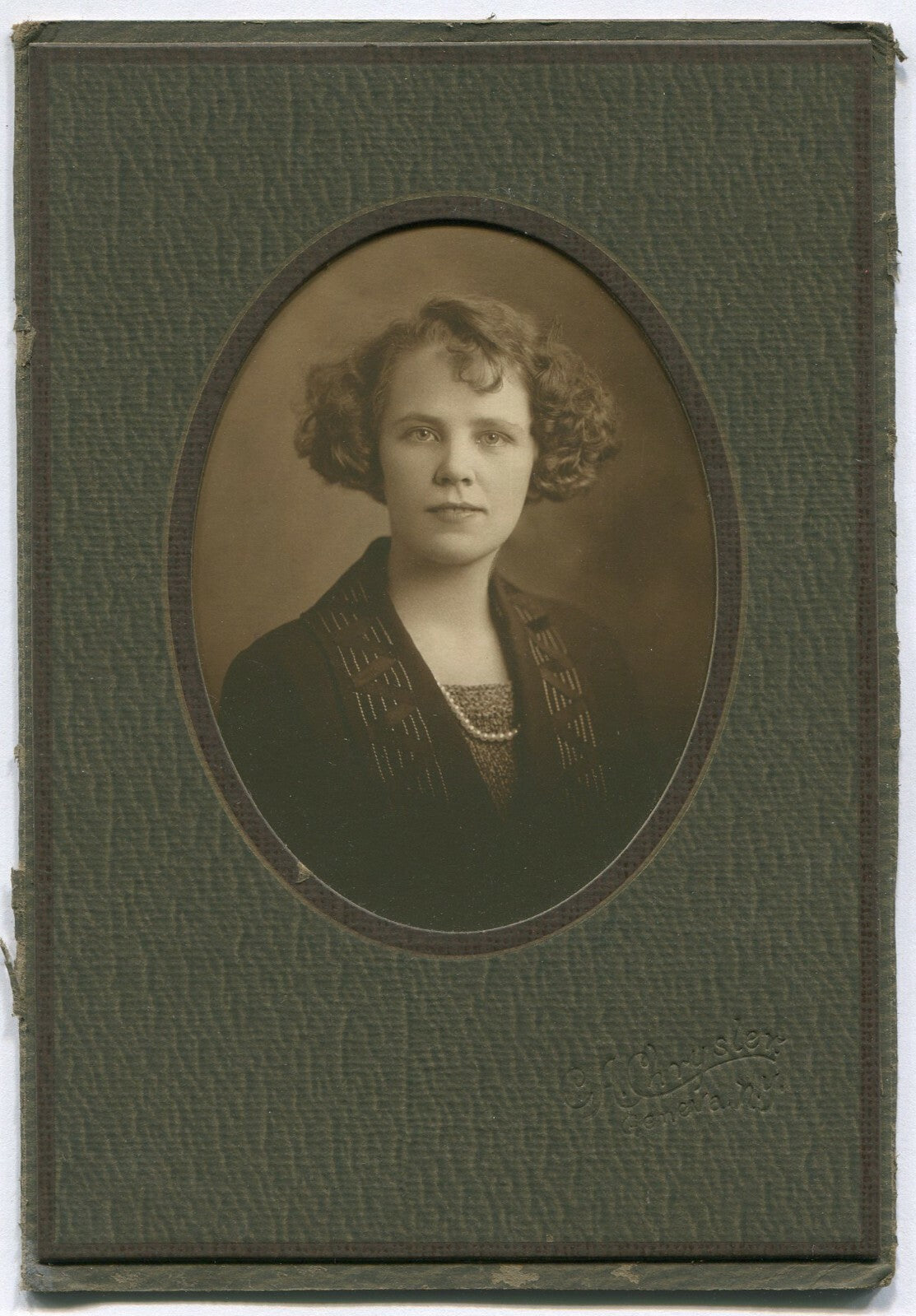 Vintage B&W portrait: Woman with short curly hair, pearls, oval 4x3 image on