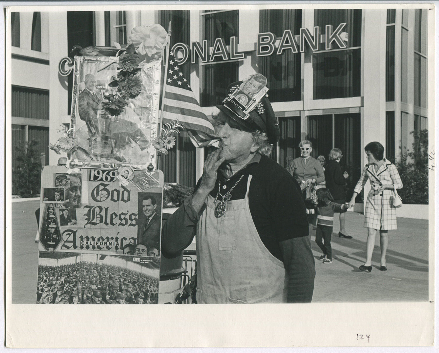 ODD MAN KISSING FLAG, CELEBRATING HIS OWN UNIQUENESS. B&W 8X10, 1969.