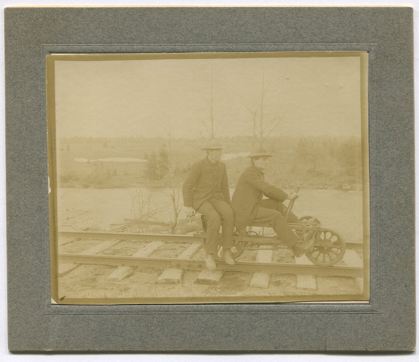 Vintage cabinet card photo: Men on railroad pedal car with photographic